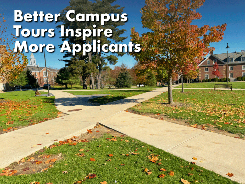 Photo of a grassy college campus quad in the fall with two intersecting sidewalks, two large broadleaf trees - one green, one orange - and two buildings off in the distance with a clear blue sky.